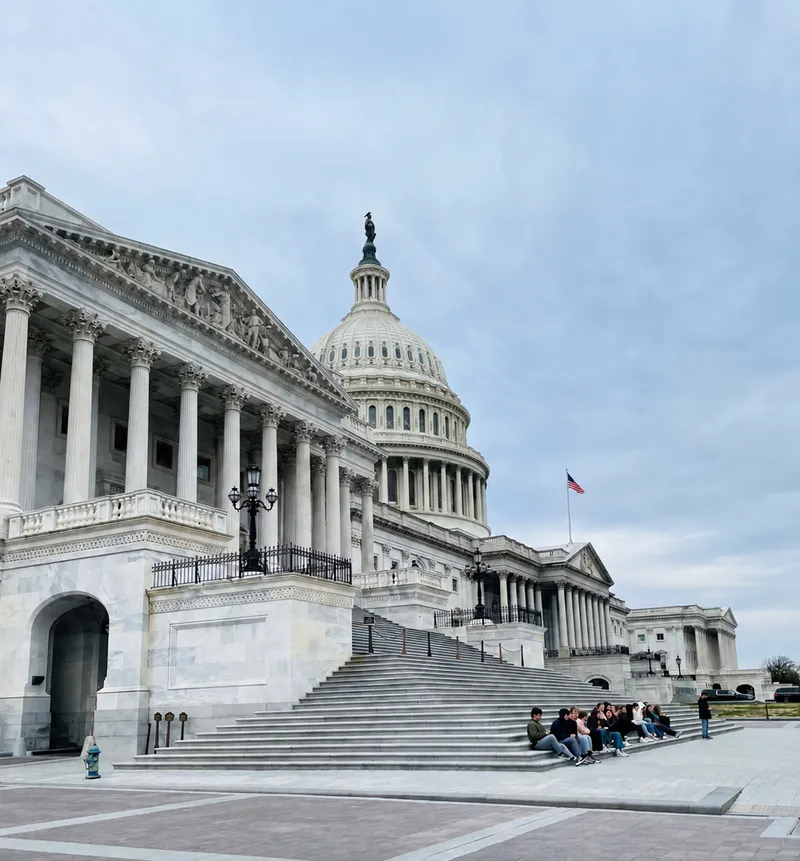 Visitors sitting on the steps of the U.S. Capitol