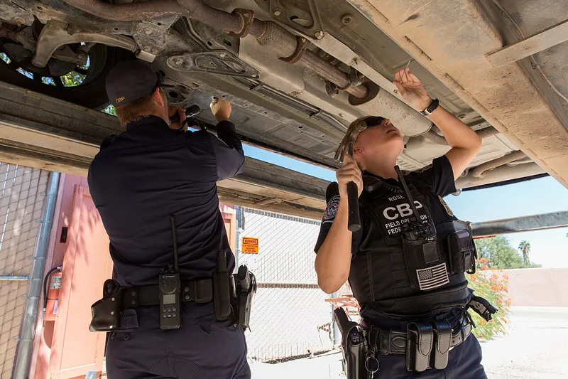 U.S. Customs and Border Protection officers inspect a vehicle in secondary inspection at the Port of Lukeville, Arizona