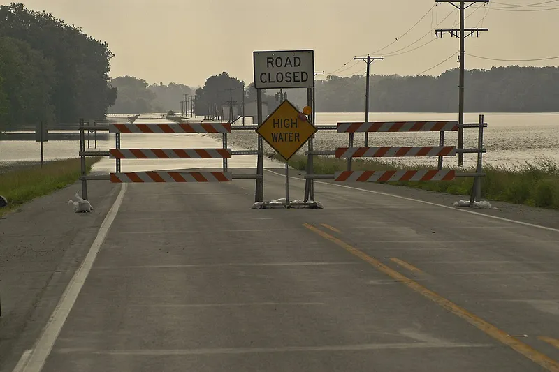 Road closed and high water signs on a flooded Indiana highway near the Wabash River during a June 2004 flood
